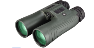 Olive-green binoculars with green lenses shown from a front-side angle, focusing on the eyepieces and textured body.