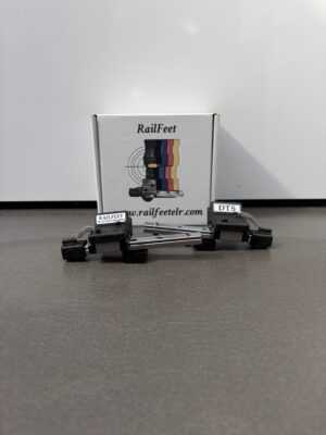 Box labeled RailFeet on a gray surface with two small black RailFeet components in front of it.